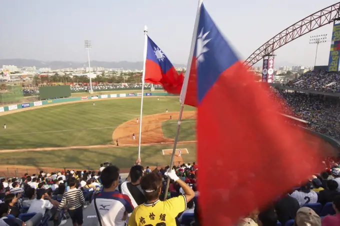 Man holding Taiwanese flag at baseball game, Taichung, Taiwan