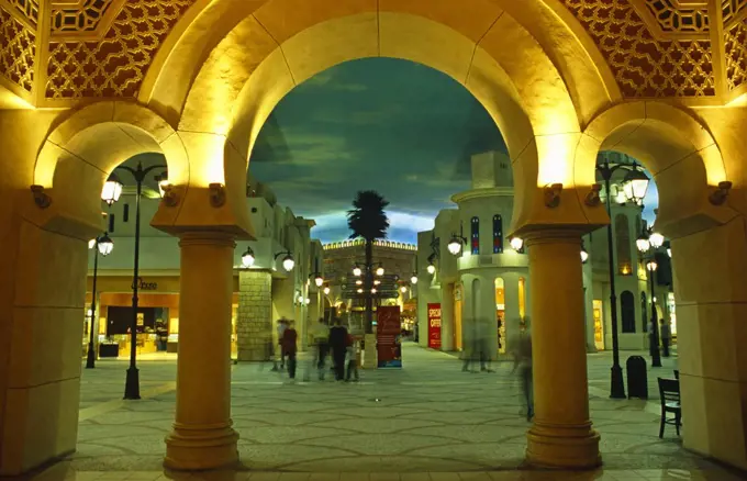 United Arab Emirates (or UAE), Dubai. False skies with clouds lend an outdoor atmosphere to Tunisia Court in the Ibn Battuta Shopping Mall.