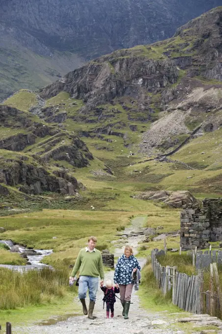 Wales, Conwy, Snowdonia. A family walking in Cwm Llan along the Watkin Path one of the routes up Snowdon.