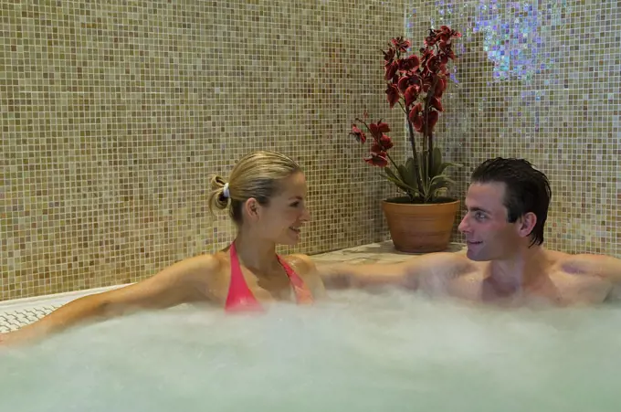 Northern Ireland, Fermanagh, Enniskillen. A couple share a jacuzzi in the Thai spa at Lough Erne Golf Resort (MR).