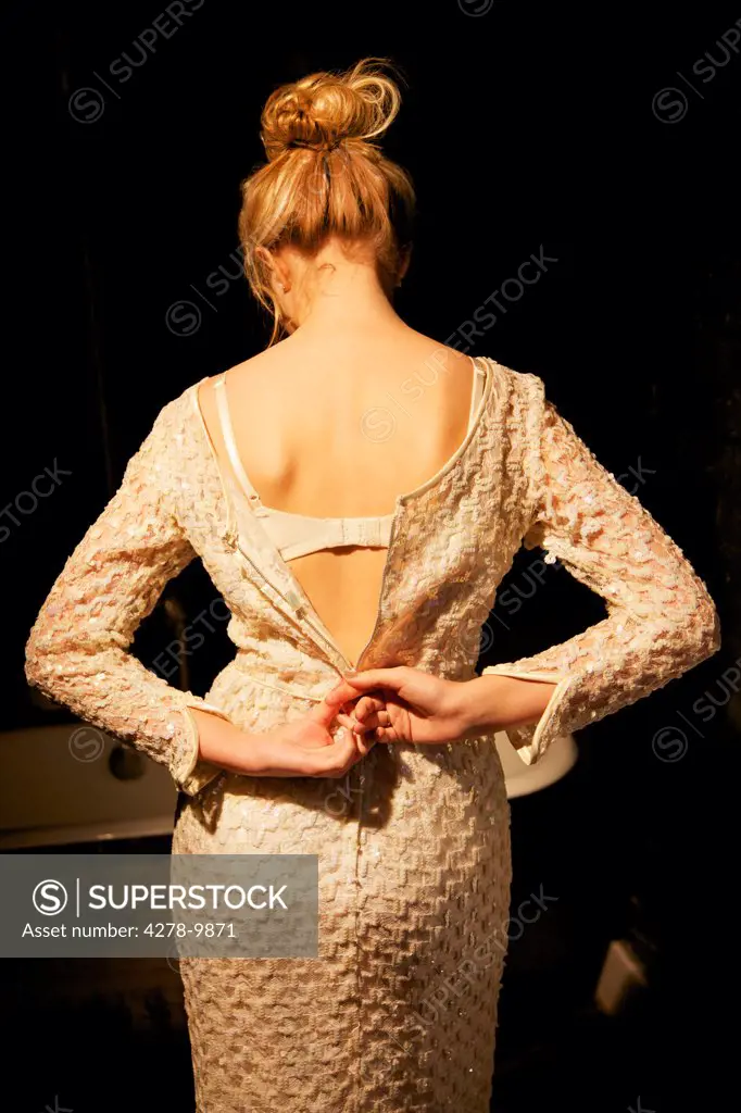 Back View of Woman Unzipping Dress