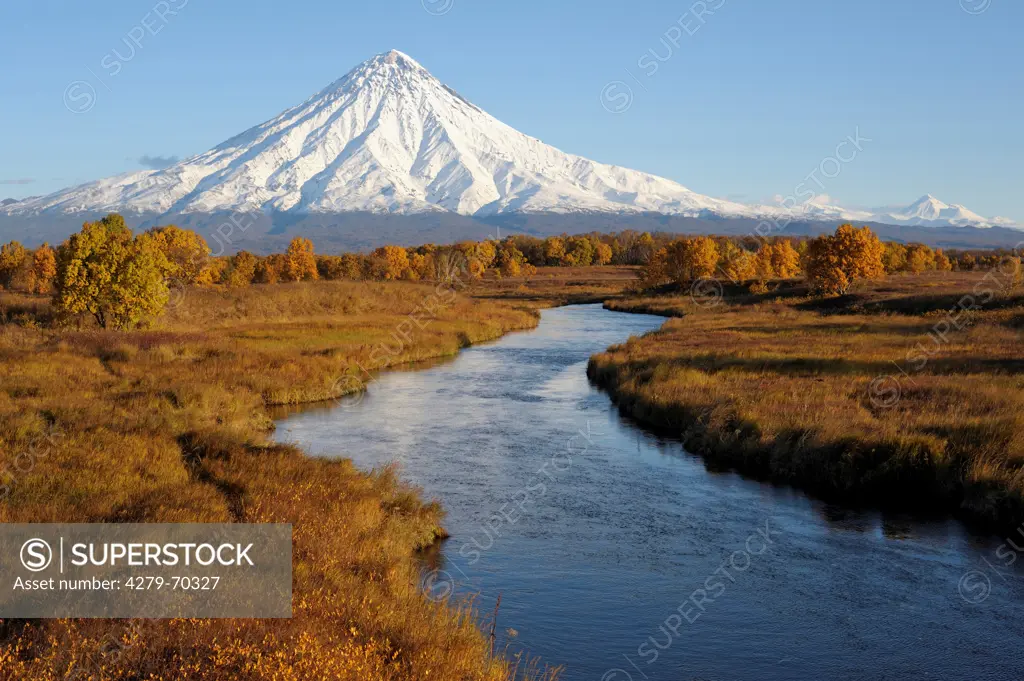 Khryukinka River in autumn with Kronotsky Volcano. Kamchatka, Russia