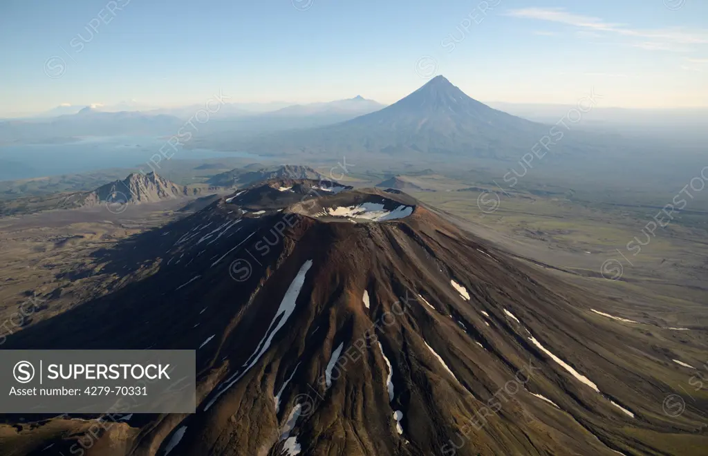 The Twin summit of Krasheninnikov Volcano with Kronotskoye Lake and Kronotsky Volcano in the background. Kamtchatka, Russia