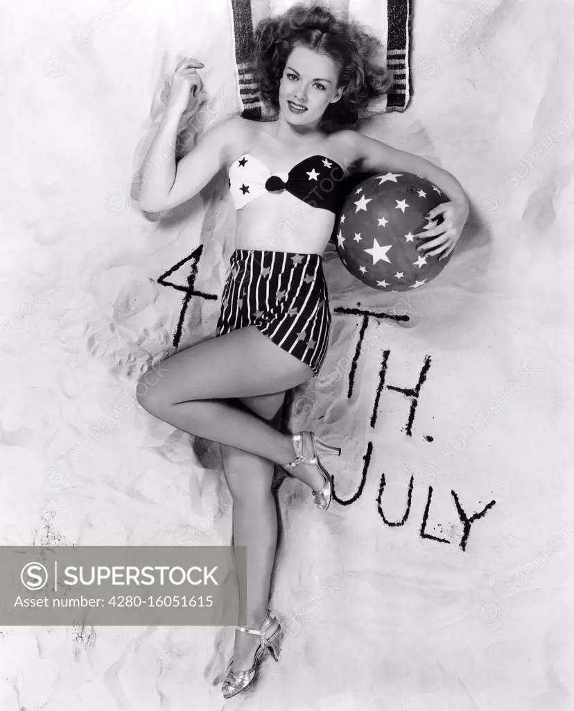 Beautiful woman with 4th July written in the sand (OV2019_123)