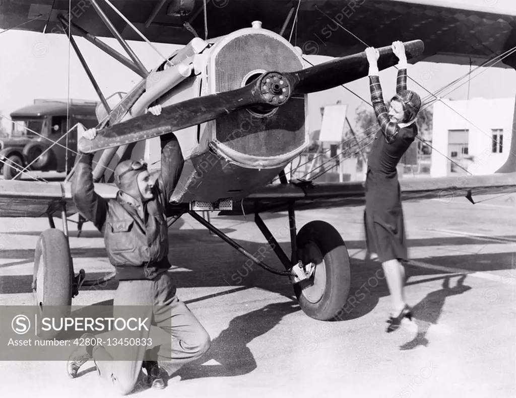 Couple playing with propeller on plane All persons depicted are not longer living and no estate exists Supplier warranties that there will be no model...