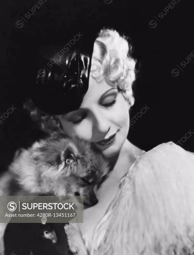 Closeup of woman with dog All persons depicted are not longer living and no estate exists Supplier warranties that there will be no model release issu...