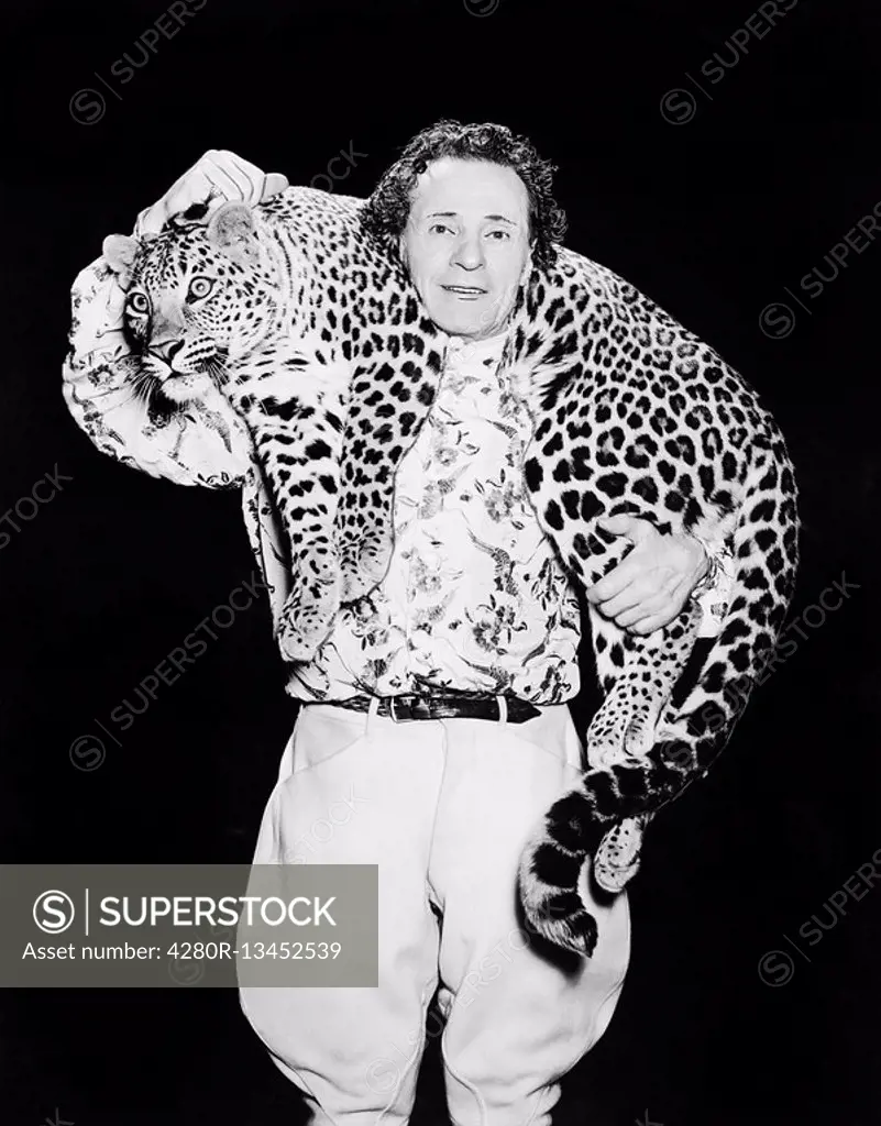 Man posing with a leopard around his neck All persons depicted are not longer living and no estate exists Supplier warranties that there will be no mo...