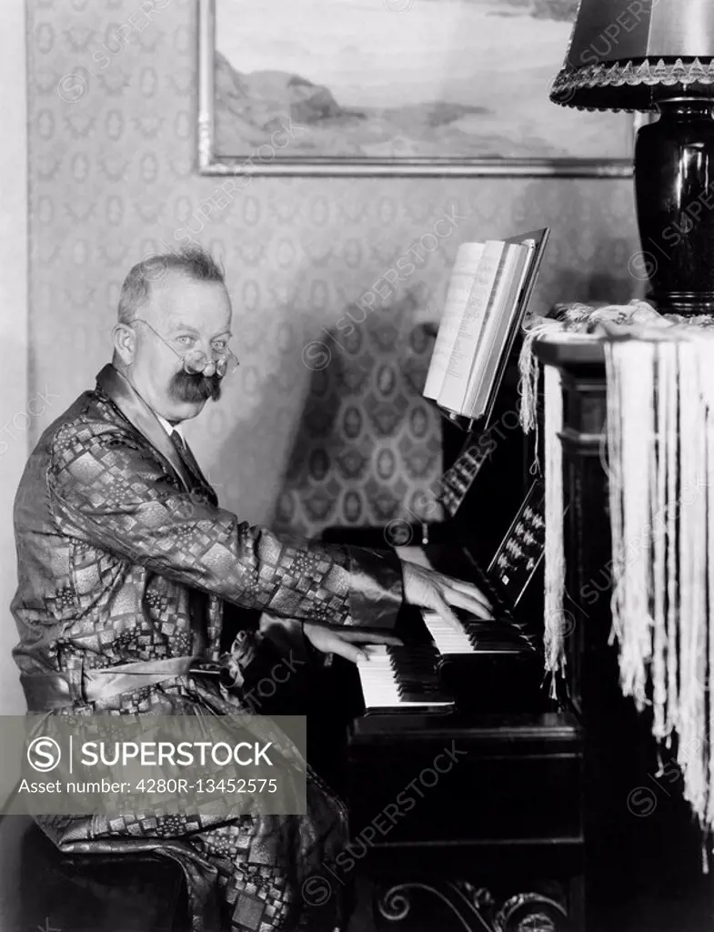 Man in a robe playing his piano in the living room All persons depicted are not longer living and no estate exists Supplier warranties that there will...