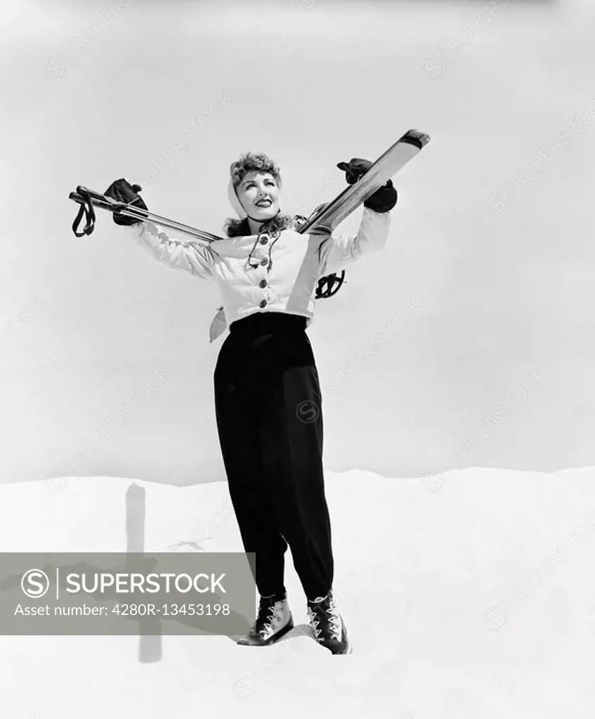 Young woman carrying ski and ski pole on her shoulders All persons depicted are not longer living and no estate exists Supplier warranties that there ...