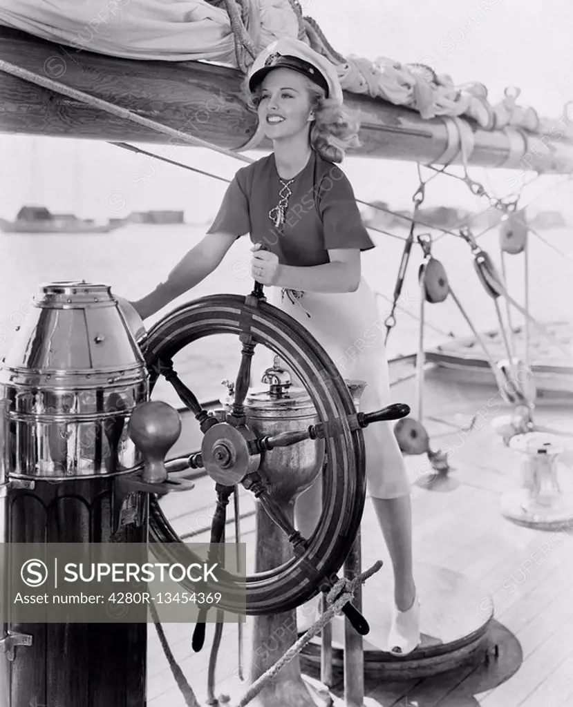 Portrait of woman steering boat All persons depicted are not longer living and no estate exists Supplier warranties that there will be no model releas...