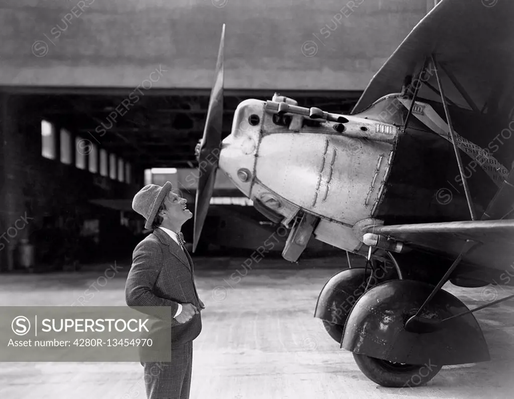 Man admiring plane All persons depicted are not longer living and no estate exists Supplier warranties that there will be no model release issues