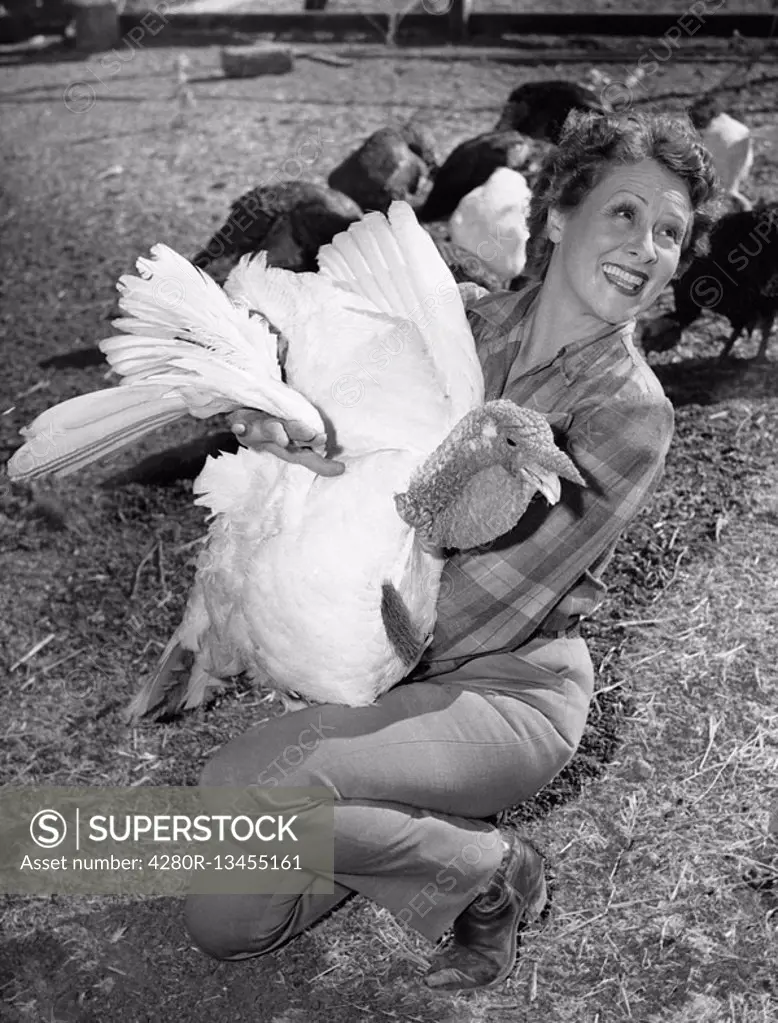 Woman holding live turkey All persons depicted are not longer living and no estate exists Supplier warranties that there will be no model release issu...