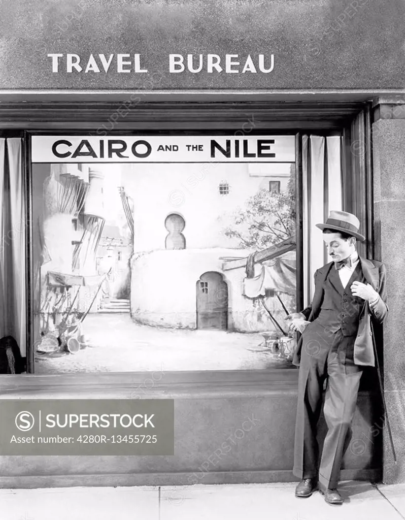 Man standing in front of a store All persons depicted are not longer living and no estate exists Supplier warranties that there will be no model relea...