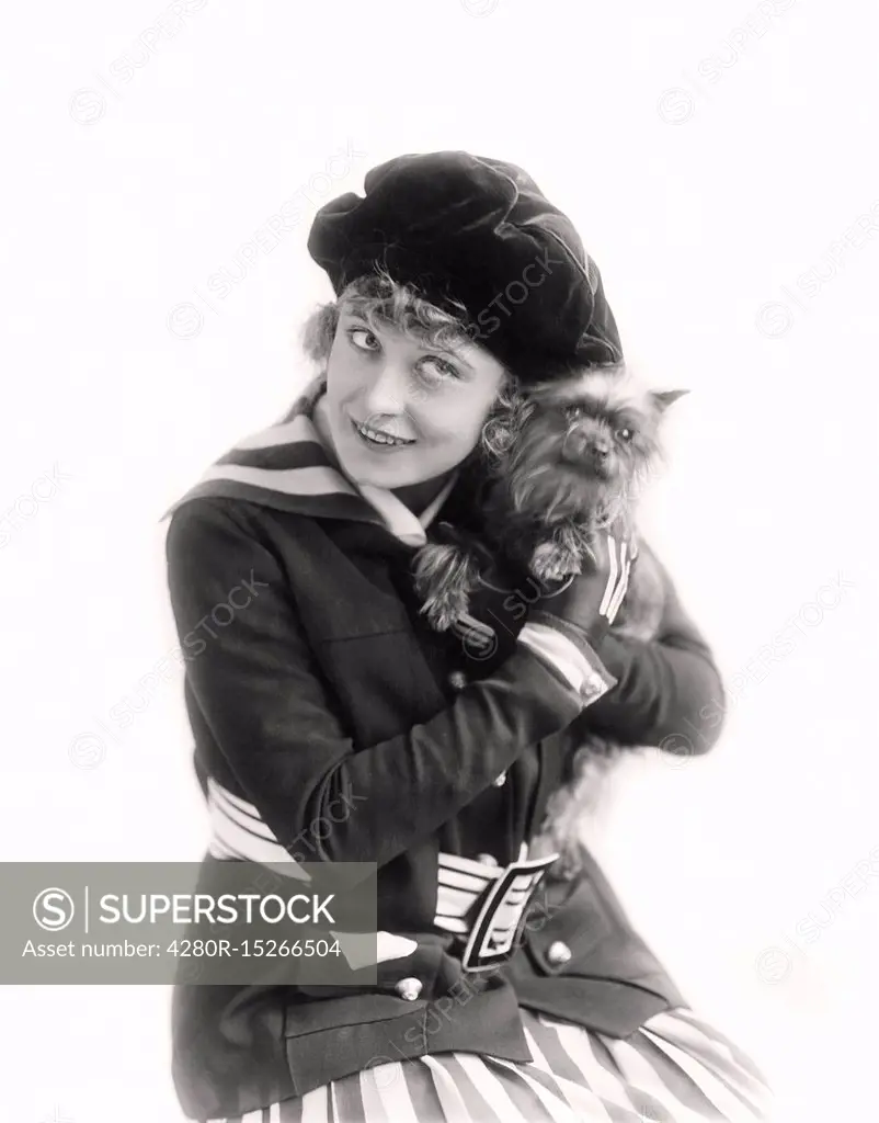 Woman cuddling her little dog