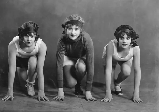 Portrait of three female runners in starting position (EV003262_H)