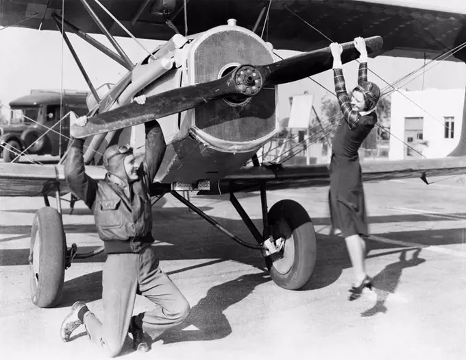 Couple playing with propeller on plane All persons depicted are not longer living and no estate exists Supplier warranties that there will be no model...