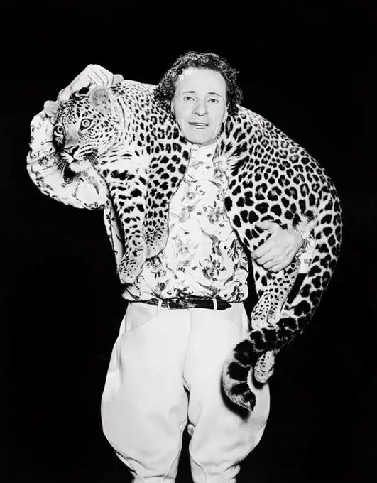 Man posing with a leopard around his neck All persons depicted are not longer living and no estate exists Supplier warranties that there will be no mo...