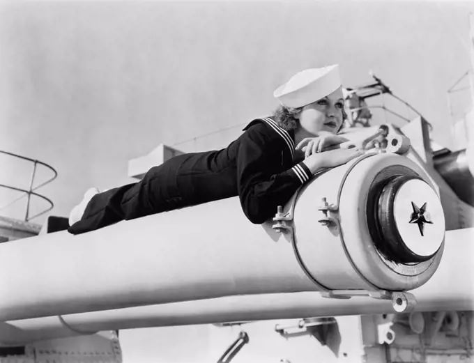 Woman in a sailors uniform lying on a cannon All persons depicted are not longer living and no estate exists Supplier warranties that there will be no...