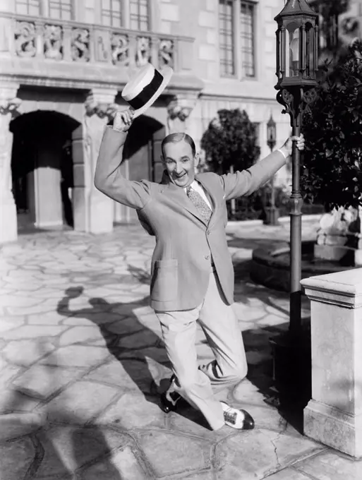 Man dancing in the street waving his hat All persons depicted are not longer living and no estate exists Supplier warranties that there will be no mod...