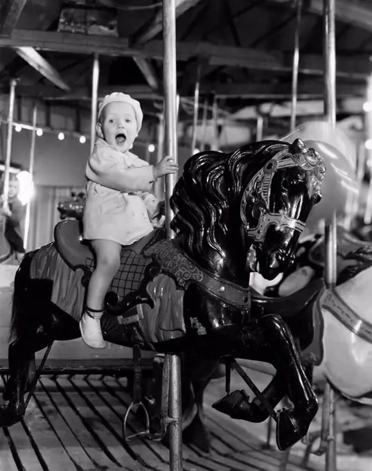 Toddler on carousel All persons depicted are not longer living and no estate exists Supplier warranties that there will be no model release issues