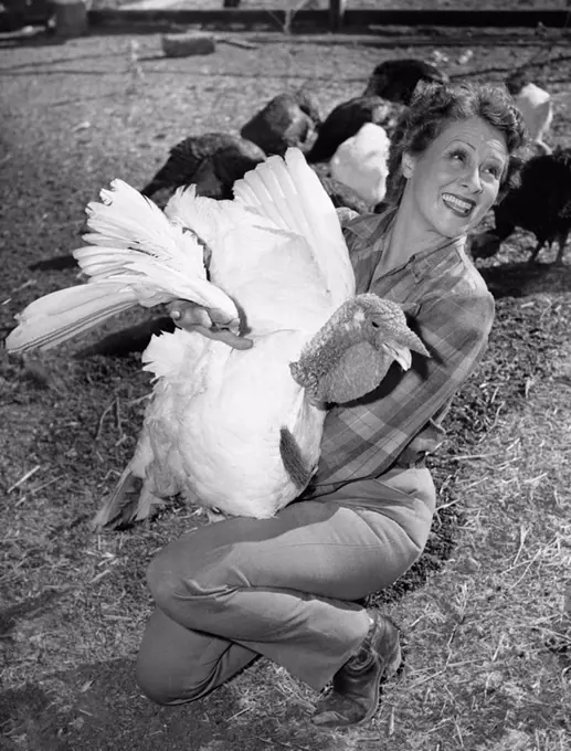 Woman holding live turkey All persons depicted are not longer living and no estate exists Supplier warranties that there will be no model release issu...