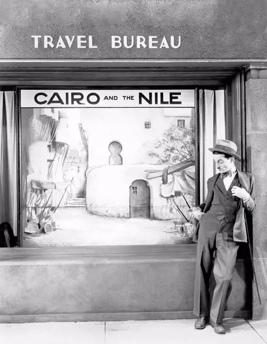 Man standing in front of a store All persons depicted are not longer living and no estate exists Supplier warranties that there will be no model relea...