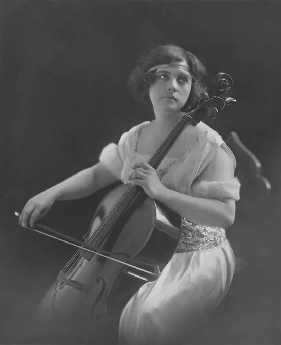 Contemplating woman plays violin