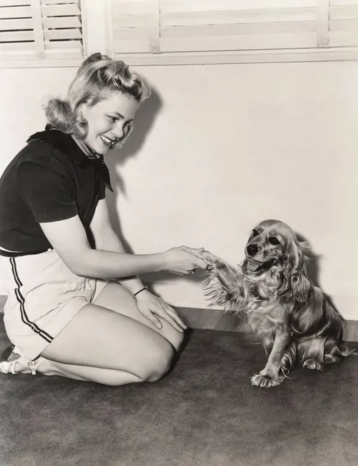 Shaking hands with her cocker spaniel (OLVI007_OU828_F)