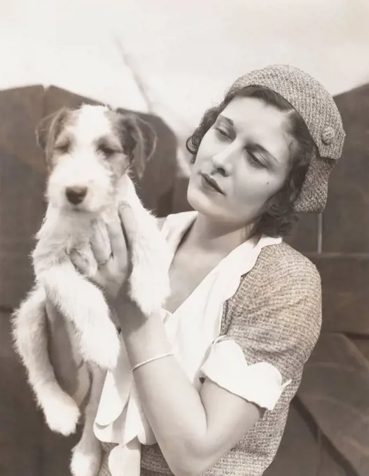 Young woman holding her wire-haired fox terrier (OLVI007_OU848_F)