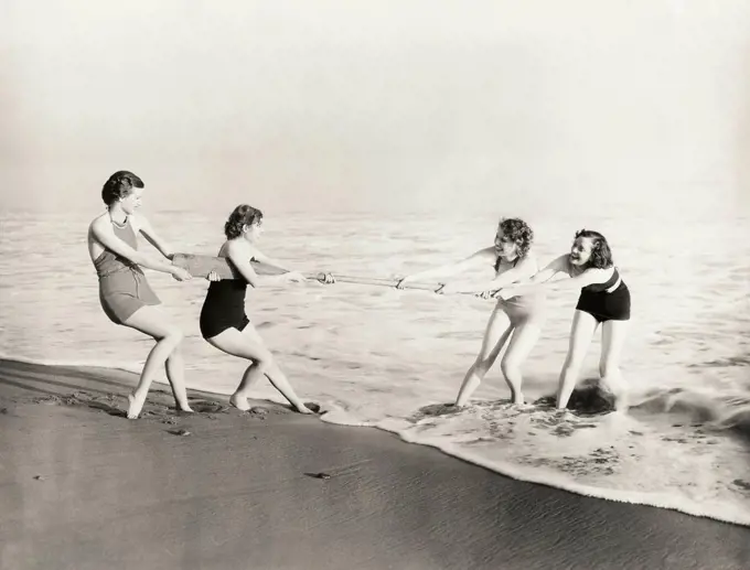 1960s 1970s ANONYMOUS BAND TEENAGE MUSICIANS AND COUPLES BOYS AND GIRLS  WEARING BATHING SUITS DANCING TOGETHER AT A BEACH PARTY - SuperStock