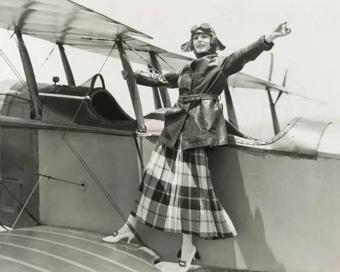 Aviatrix standing on bi-plane (OLVI008_OU309_F)