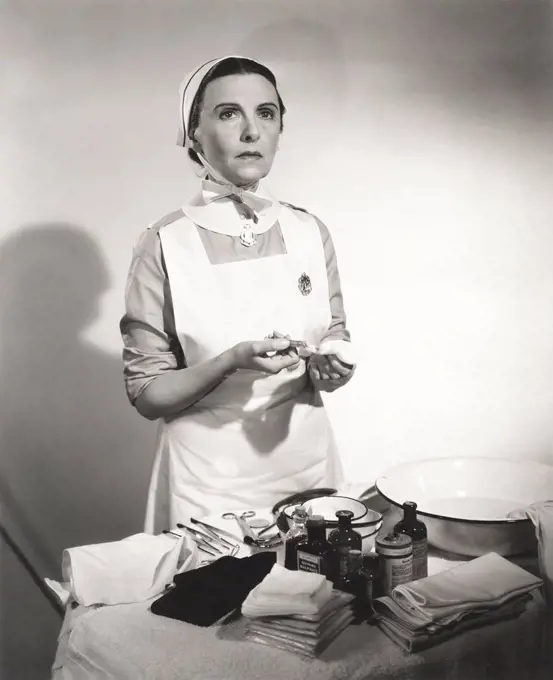 Nurse preparing syringe for injection