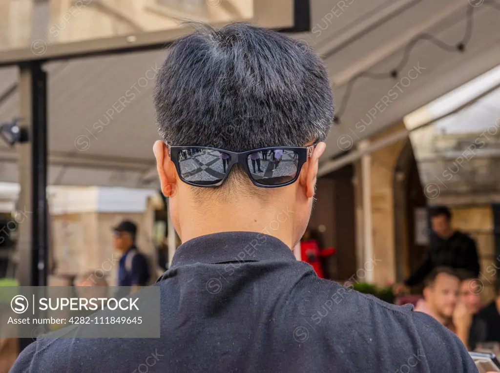 Man wearing sunglasses on back of head in Prague in the Czech Republic.