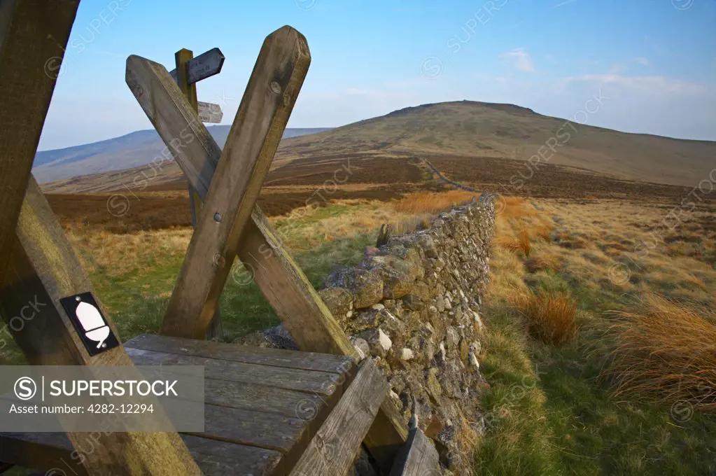 Scotland, Scottish Borders, The Penine Way. Ladder Stile over a wall marking the England / Scotland border with the Schil in the distance.