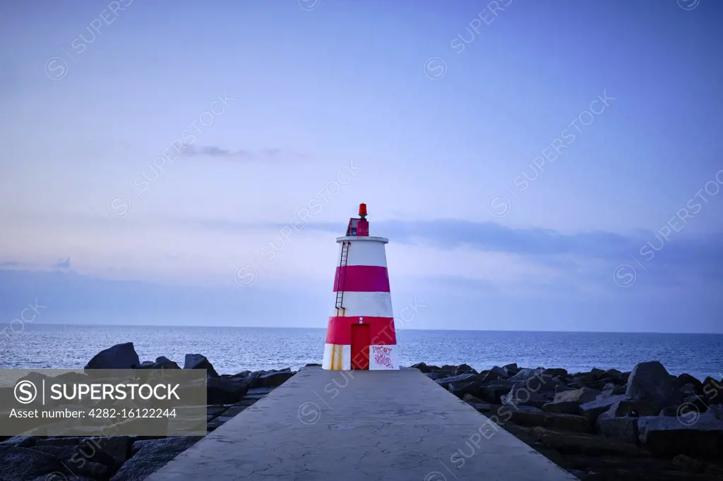 A lighthouse off the coast of Portugal on an early January morning.