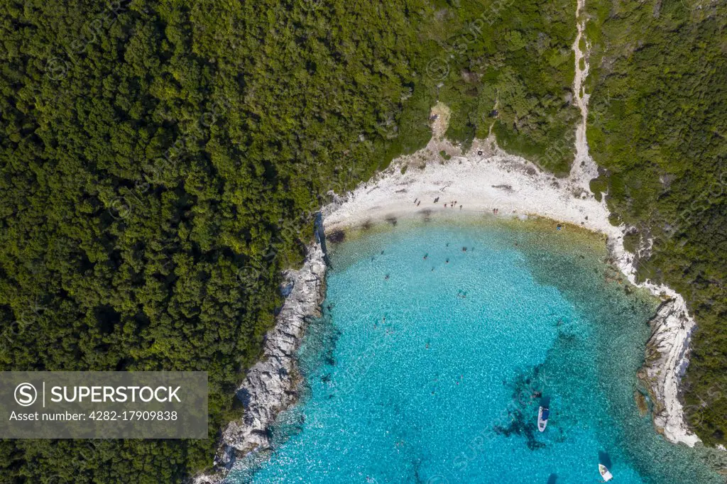 Aerial of an isolated beach with turquoise waters in Greece.