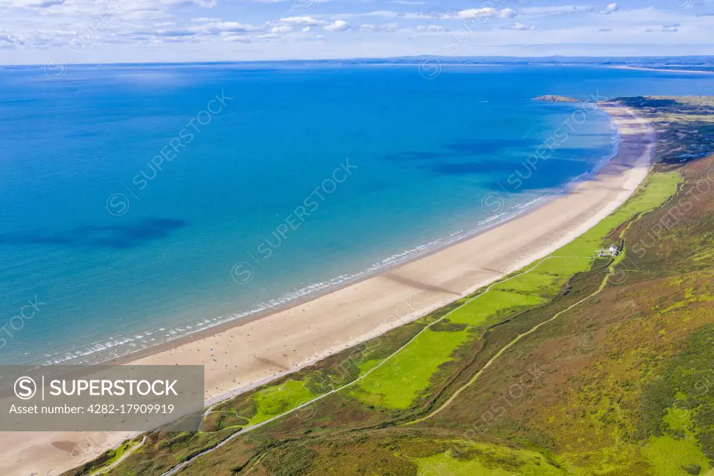 Aerial view of the longest beach in Rhossili Bay in Gower in Wales.