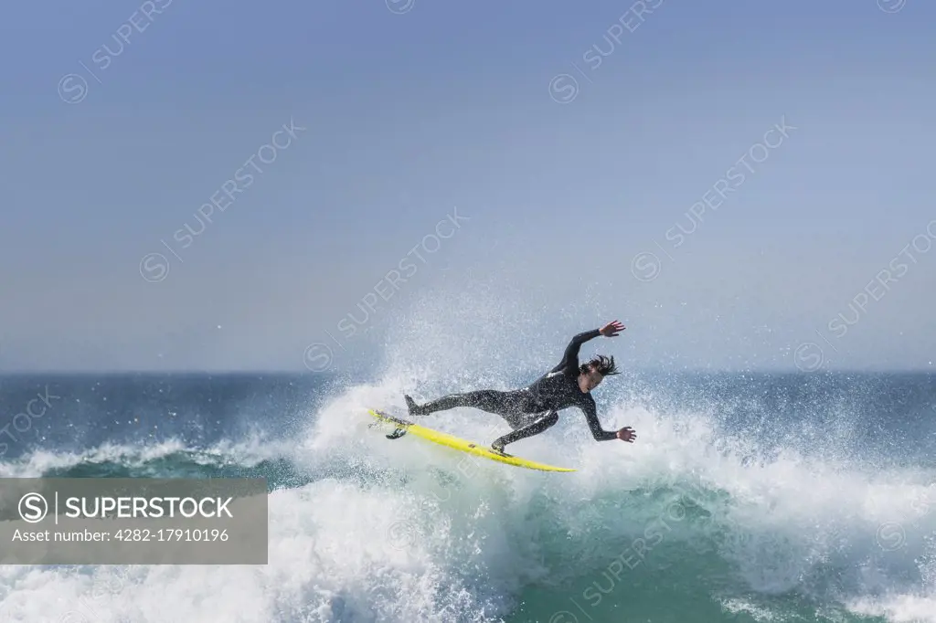 Spectacular action as a surfer rides a wave at Fistral in Newquay in Cornwall.