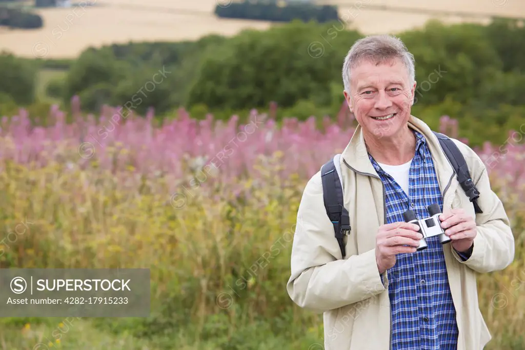 Senior Man On Walk With Binoculars