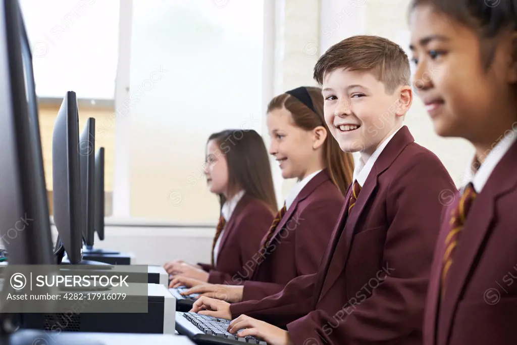 Pupils Wearing School Uniform In Computer Class 