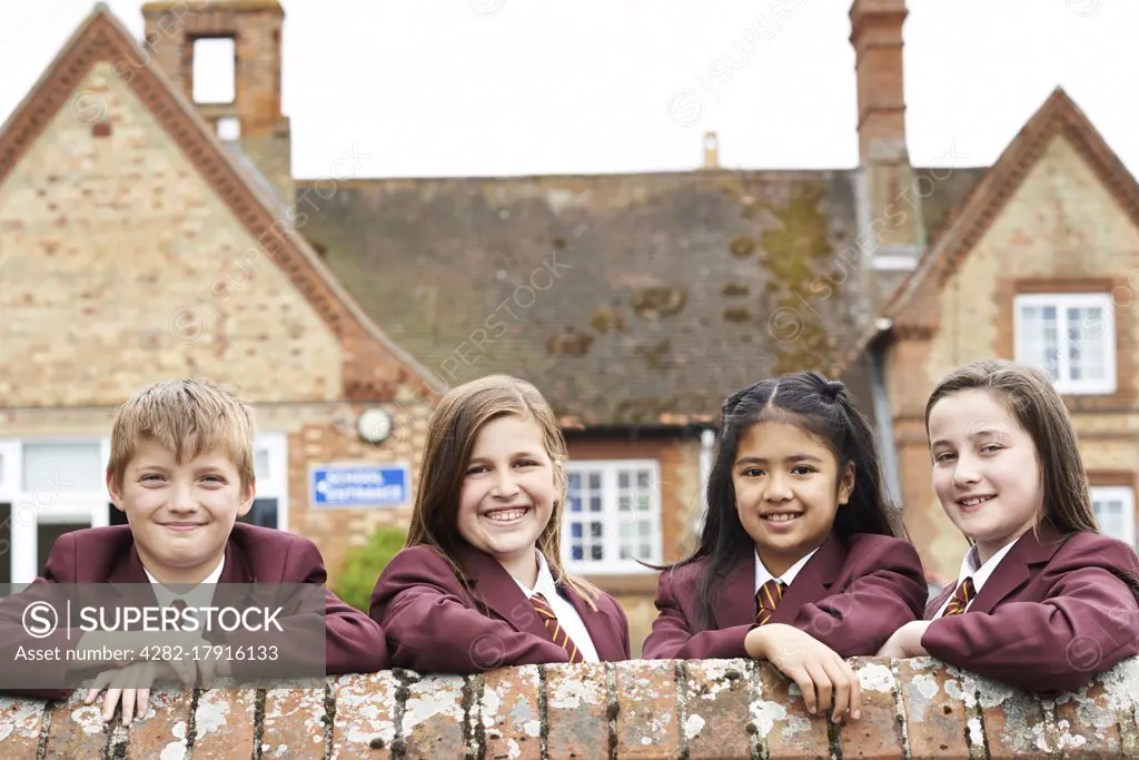 Portrait Of Pupils In Uniform Outside School Building