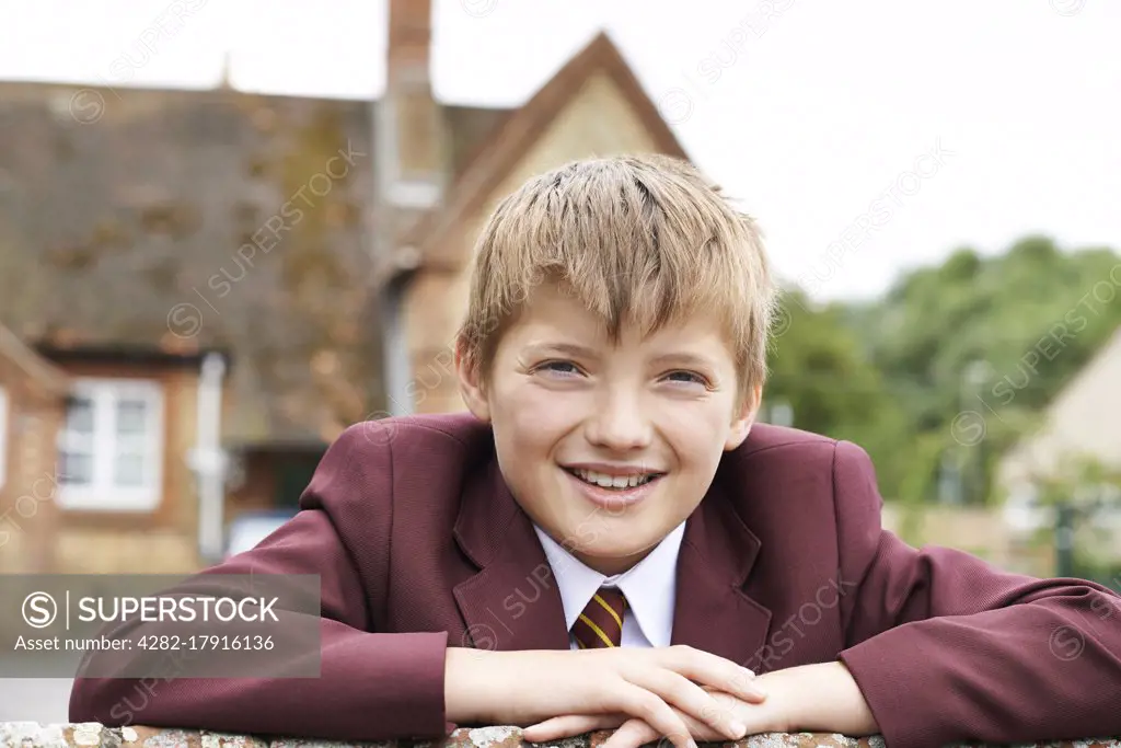 Portrait Of Boy In Uniform Outside School Building