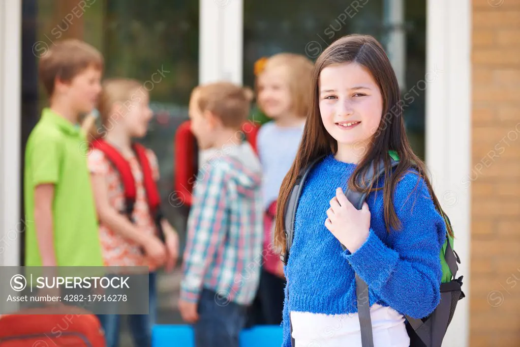 Girl Standing Outside School With Rucksack