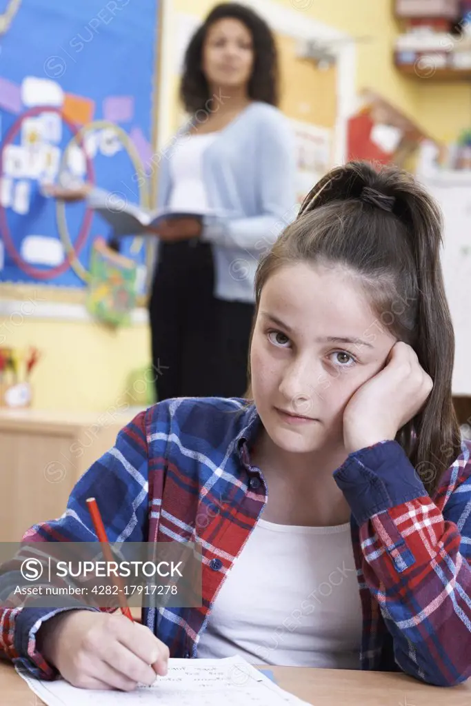 Female Elementary School Pupil Struggling In Class