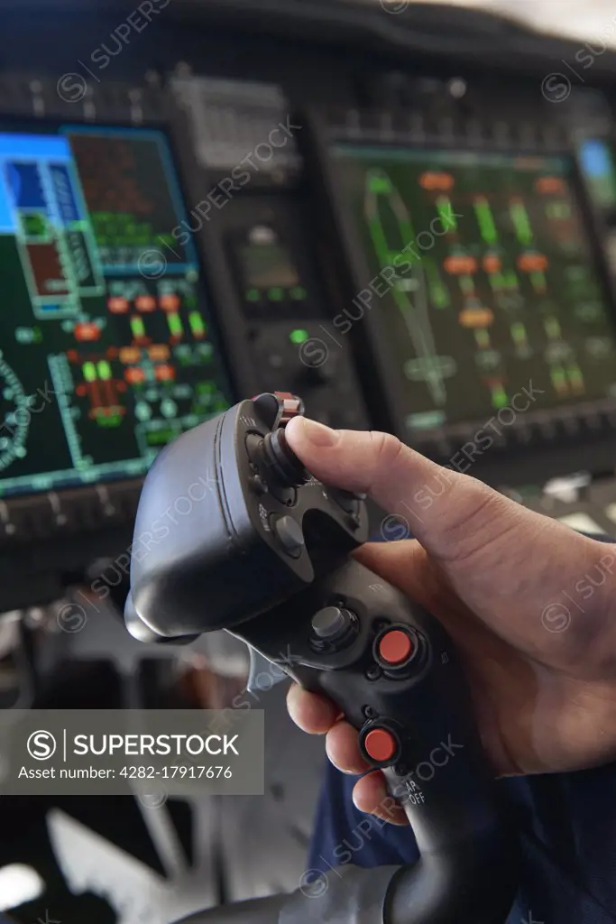 Close Up Pilot Holding Joystick In Helicopter Cockpit