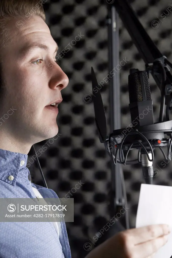 Man In Recording Studio Talking Into Microphone