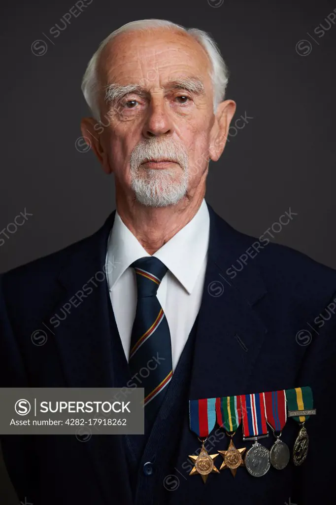 Studio Portrait Of Senior Man Wearing Medals