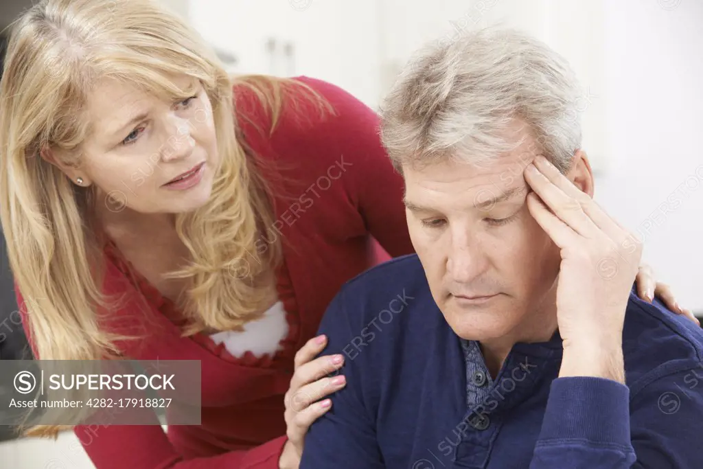 Mature Woman Comforting Man With Depression