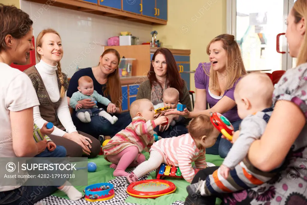 Group Of Mothers With Babies At Playgroup