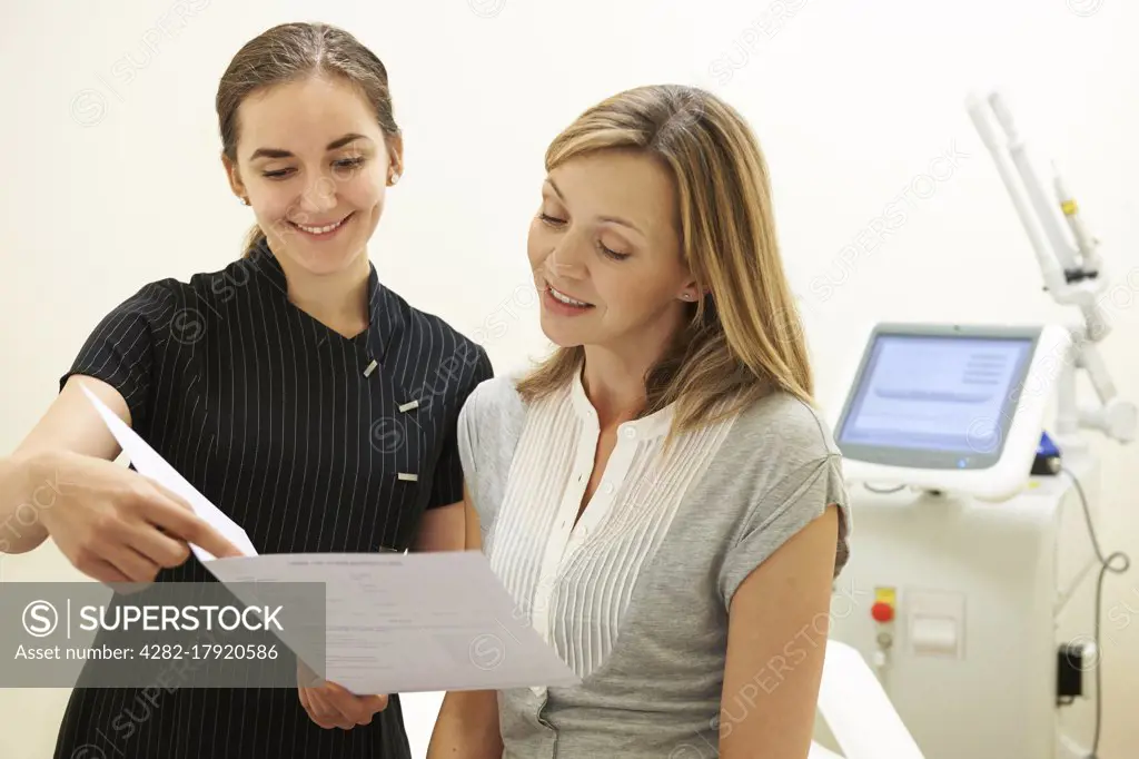 Beautician Discussing Treatment With Female Client